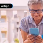 imagem de pessoa idosa mexendo no celular feliz