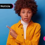 Pessoa jovem de cabelo castanho escuro solto com o dedo indicador apontando para o lado com expressão de surpresa.