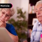 Duas pessoas de idade lendo com expressão de dúvida.