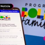 Pessoa segurando o celular com tela do bolsa família