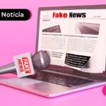 Imagem representando um notebook com tela escrito fake news