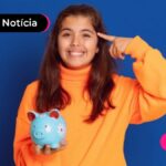 Pessoa de camisa laranja com um cofrinho em mãos