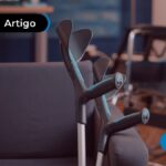 Sala de espera de uma clínica com sofá azul e bengalas.