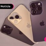 Três celulares de cores variadas espalhados em mesa.