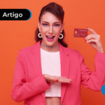 Pessoa sorrindo segurando um cartão de crédito