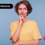 Jovem com expressão de dúvida após ler notícia sobre crédito do trabalhador.