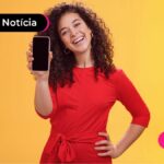 jovem sorridente mostrando o celular