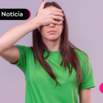 Pessoa de blusa verde com a mão na testa.