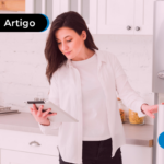 Mulher mexendo no tablet abrindo a geladeira.