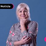 Pessoa de idade sorrindo após ler notícia sobre leilão de taxas do INSS.