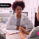 Pessoa conversando com pessoa de jaleco em clínica hospitalar.
