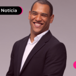 Homem de terno sorrindo.