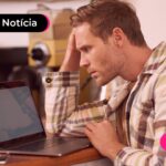 Pessoa preocupada olhando o computador com receio dos golpes do Desenrola Brasil
