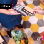 Pessoa realizando um pagamento em maquininha de cartão.
